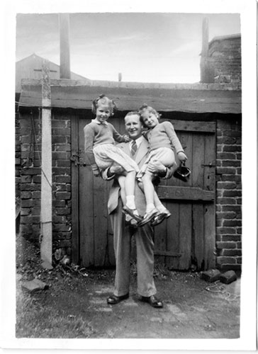 Father Lifting Two Daughters